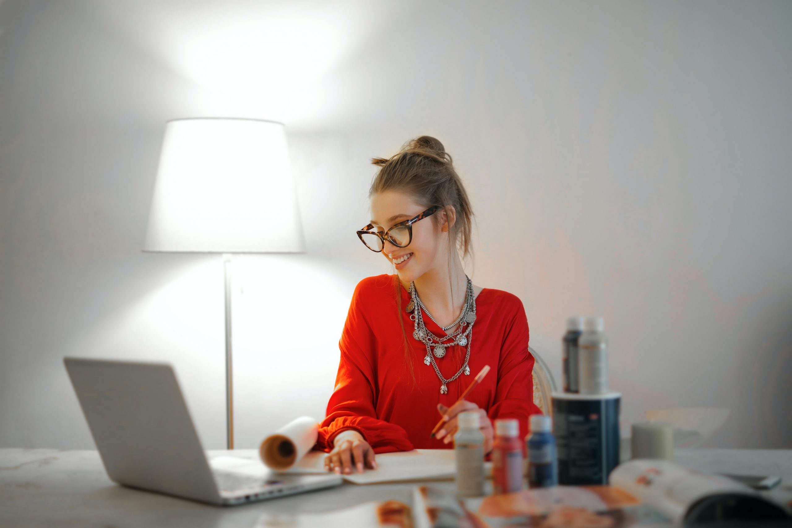 woman-in-red-long-sleeve-shirt-looking-at-her-laptop-3765132